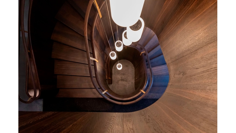 A spiral staircase leads to the upper floor of the Endress+Hauser guest house.