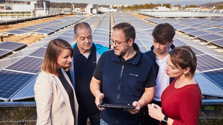 Endress+Hauser-medarbetare på taket framför solpanelsystemet.