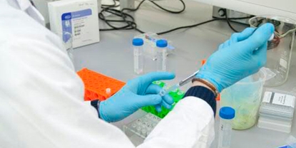 Food & beverage lab worker takes process manual grab samples for analysis in the plant's lab